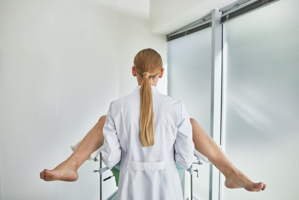 Gynecologist examining patient 